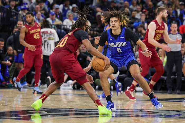 Dec 11, 2023; Orlando, Florida, USA; Orlando Magic guard Anthony Black (0) defends Cleveland Cavaliers guard Darius Garland (10) during the second half at Amway Center. Mandatory Credit: Mike Watters-USA TODAY Sports